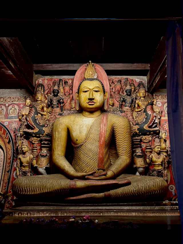 Entrance and painted interior of the Dambulla Cave Temple showing ancient Buddhist murals and statues
