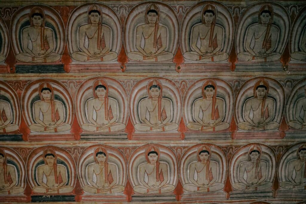 Entrance and painted interior of the Dambulla Cave Temple showing ancient Buddhist murals and statues — supporting travel image 2