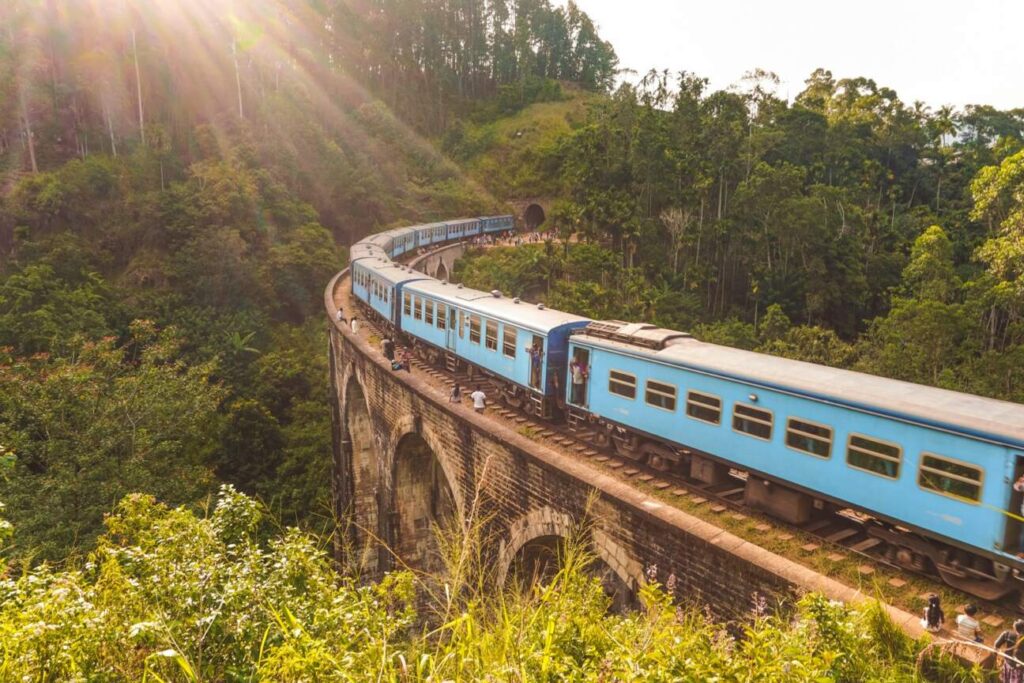 Scenic train passing through lush tea plantations in Sri Lanka's hill country near Ella — supporting travel image 2