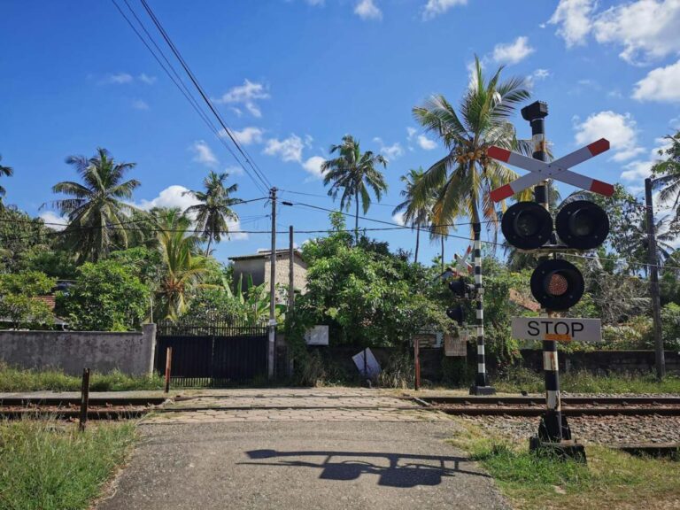 Modern railway station platform with trains and passengers in Hikkaduwa, Sri Lanka