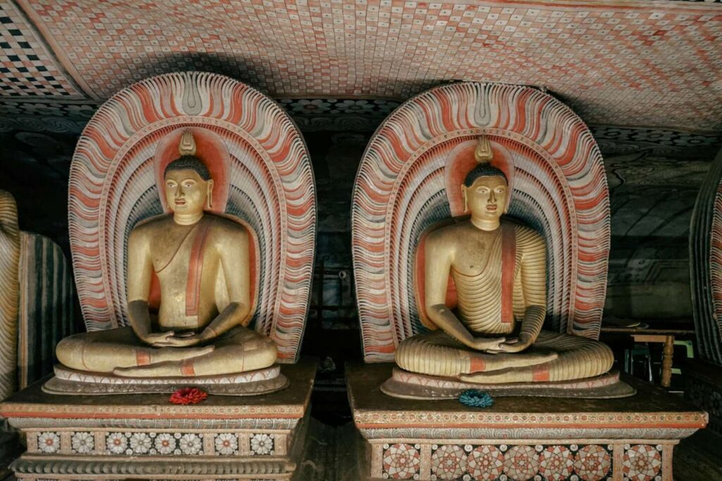 Entrance and painted interior of the Dambulla Cave Temple showing ancient Buddhist murals and statues