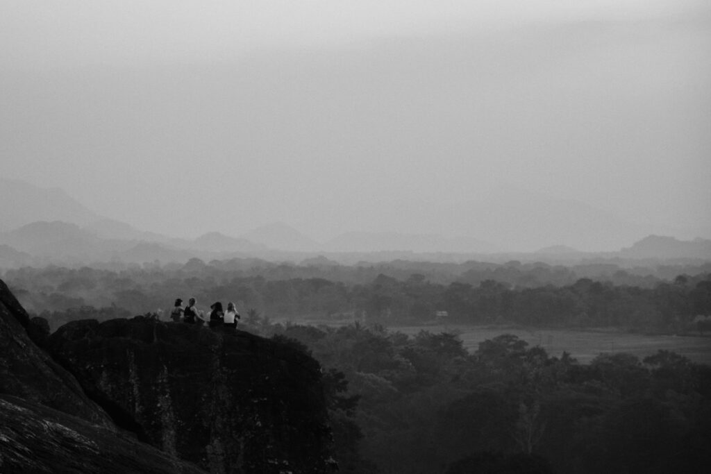 Sunset view of Sigiriya Rock from Pidurangala Rock with lush greenery surrounding — supporting travel image 2