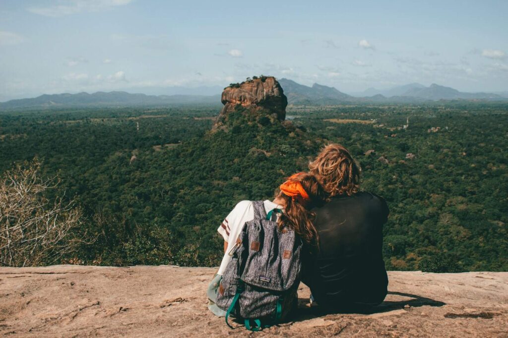 Sunset view of Sigiriya Rock from Pidurangala Rock with lush greenery surrounding
