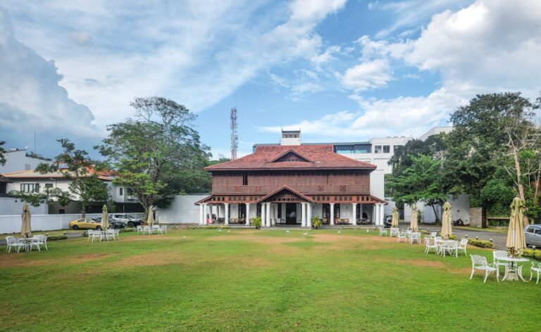 View of a restored historic villa with colonial architecture inside Galle Fort, Sri Lanka, showing weathered walls and modern design elements